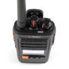 Close-up of a black handheld two-way radio with an antenna, display screen, and orange Menu button in view from above.